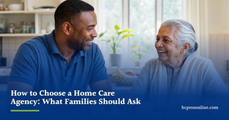 A caregiver and an older woman chat over tea at a sunny kitchen table in her home.